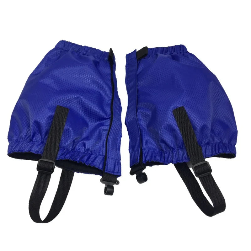 Pair of blue gaiters with black straps on a white background - offered by the Northeast's best camping and hiking gear provider, The Adirondack Tool Co.