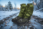 Green hiking gaiters covering black hiking boots on a white background offered by the Northeast's best camping and hiking gear provider, The Adirondack Tool Co.