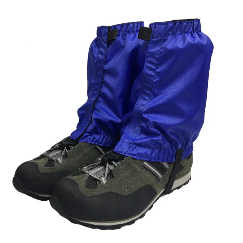 Blue gaiters over black hiking boots on a white background offered by the Northeast's best camping and hiking gear provider, The Adirondack Tool Co.