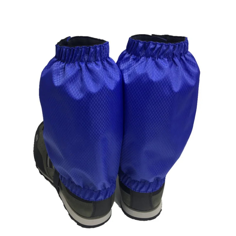 Pair of blue gaiters over black boots on a white background - offered by the Northeast's best camping and hiking gear provider, The Adirondack Tool Co.