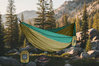 Green and beige hammock with carrying bag and accessories on a white background - offered by the best camping gear store in the northeast, the Adirondack Tool Co.