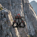 Black climbing harness with red D-ring labels