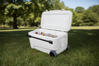 White cooler box with bottles and ice on a white background - offered by the premier camping and hiking gear store in the Northeastern United States, The Adirondack Tool Co.