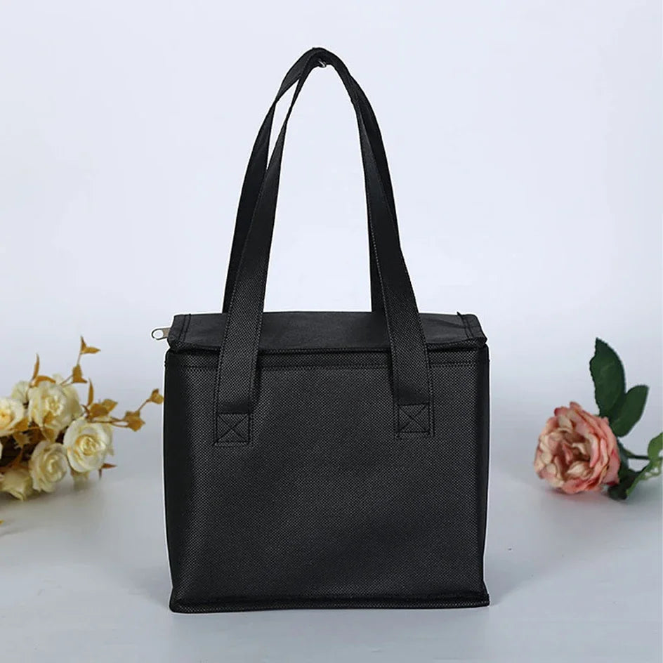 Black cooler / insulation bag on a white background with flowers - offered by the most reliable camping, hiking, and climbing gear store in the New England region, The Adirondack Tool Co.