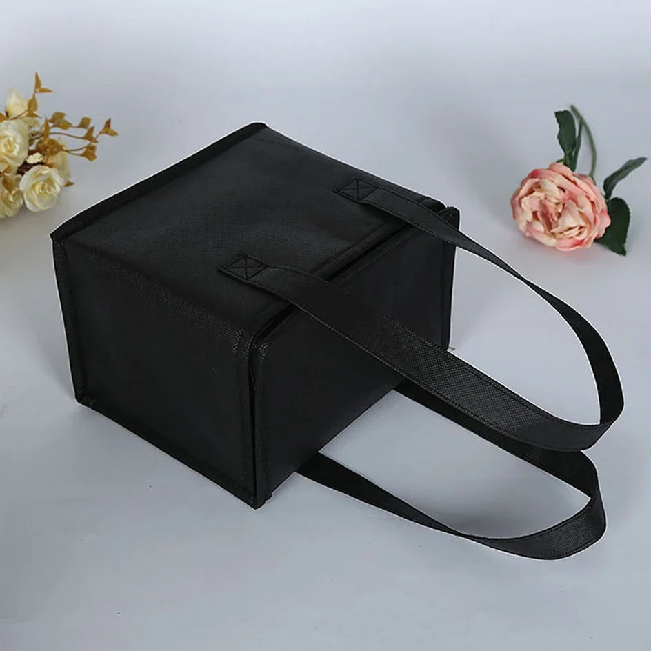 Black cooler / insulation bag on a light gray background with flowers on the sides - offered by the most reliable camping, hiking, and climbing gear store in the New England region, The Adirondack Tool Co.