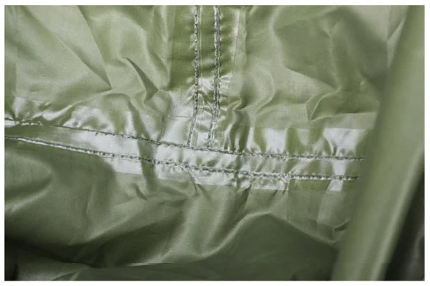 Close-up of a green 2-in-1 tarp and poncho's fabric with stitching detail - offered by the best hiking gear store in New York, The Adirondack Tool Co.