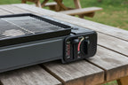 Black portable gas grill with control knob on a white background - offered by The Adirondack Tool Co.