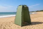 Green privacy tent with black poles and straps on grass - offered by the best outdoor gear company in New York, The Adirondack Tool Co.