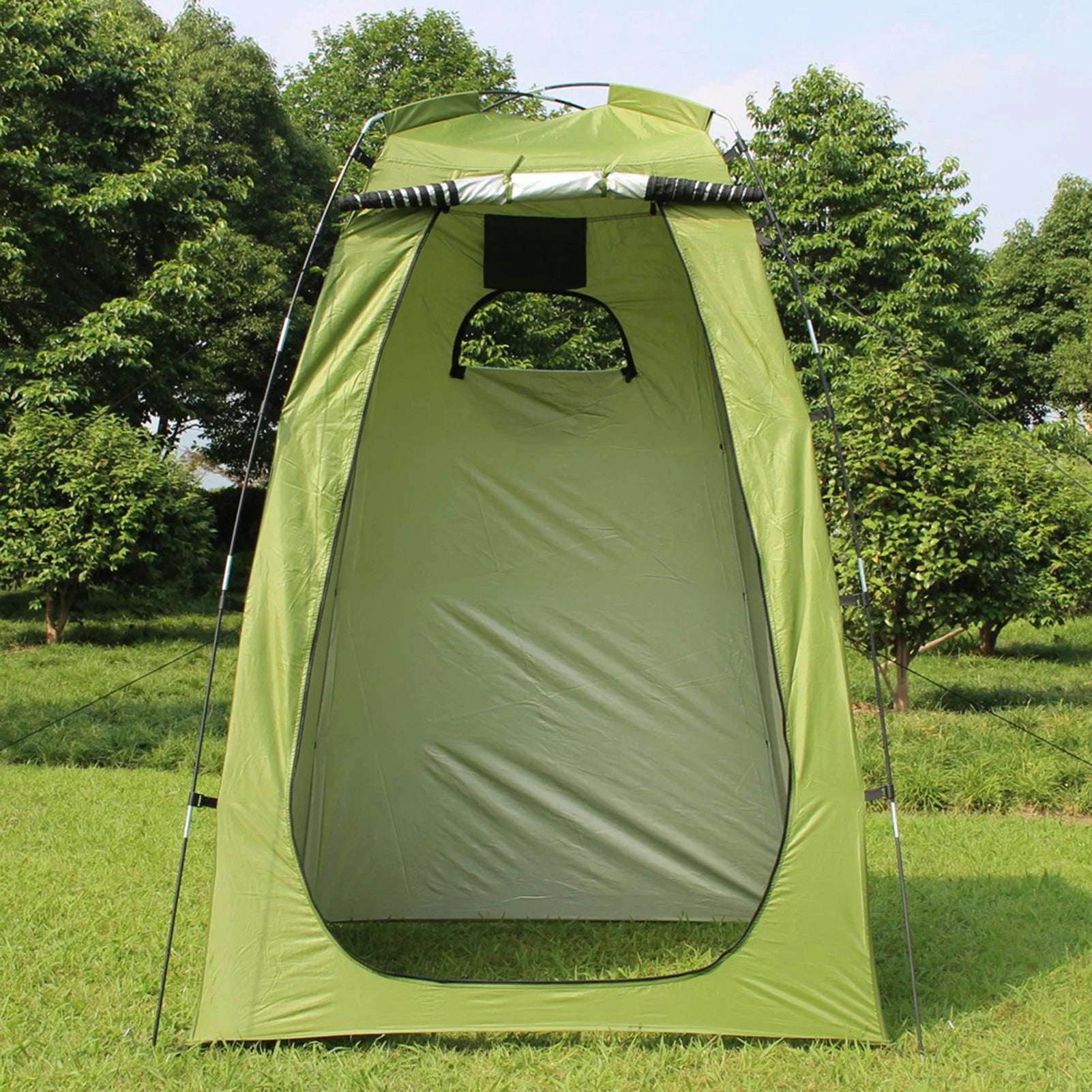 Green privacy tent with black poles and straps with a forest background - offered by the best outdoor gear company in New York, The Adirondack Tool Co.