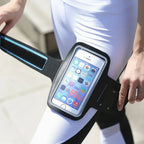 Person wearing a black phone armband with a smartphone displaying app icons - Offered by The Adirondack Tool Co.