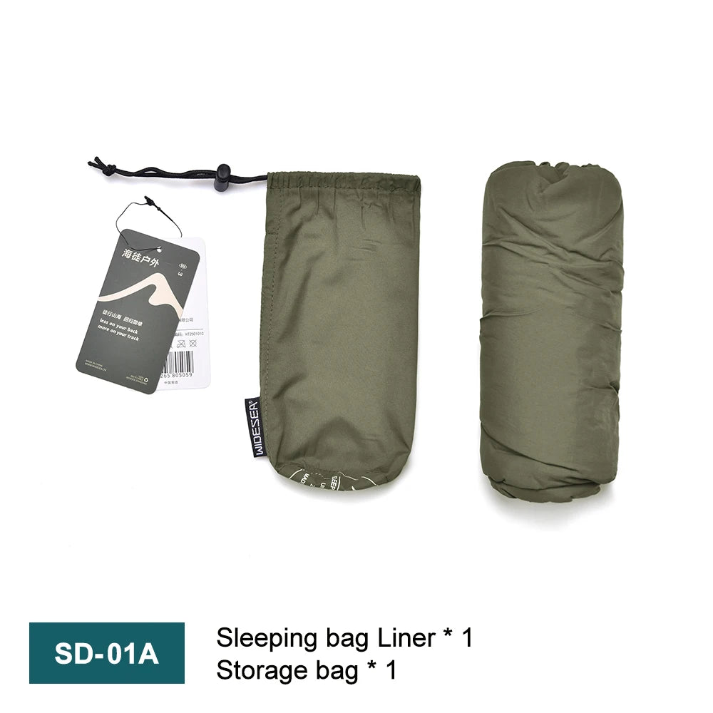 Green sleeping bag liner with storage bag on a white background