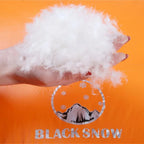 Hand holding white goose down feather insulation that is inside The Adirondack Tool Co.'s goose down sleeping bag