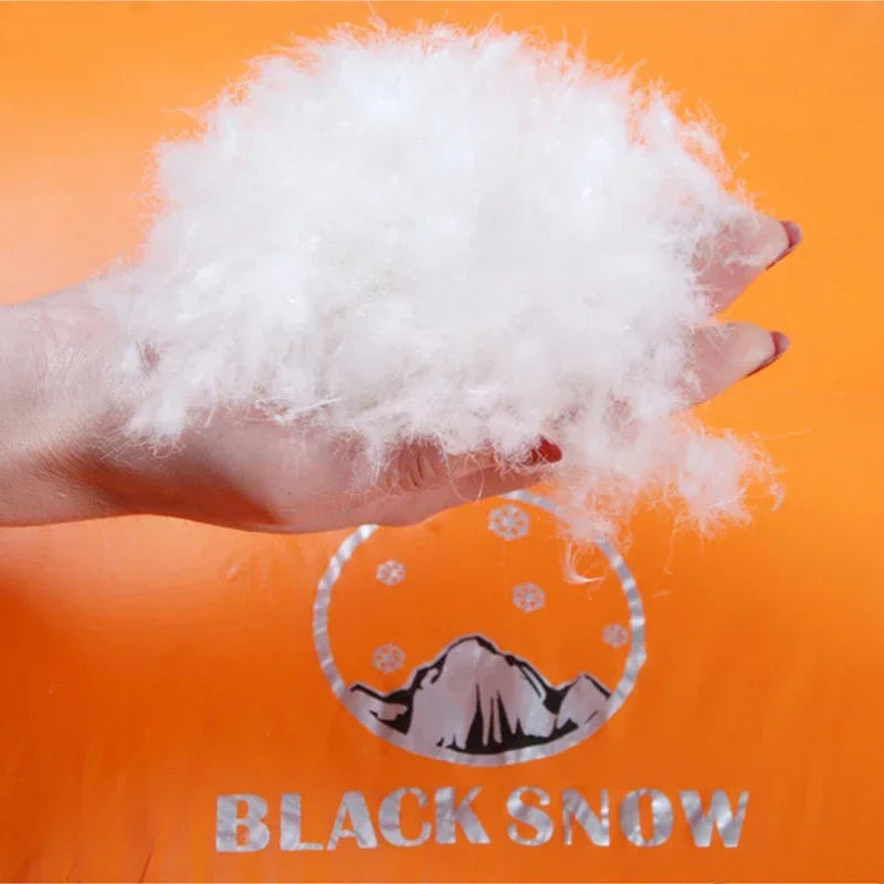 Hand holding white goose down feather insulation that is inside The Adirondack Tool Co.'s goose down sleeping bag