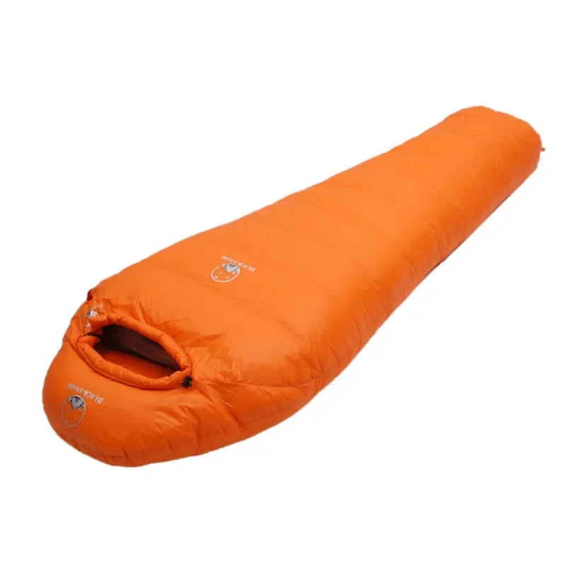 Orange sleeping bag from Black Snow and The Adirondack Tool Co. on a white background