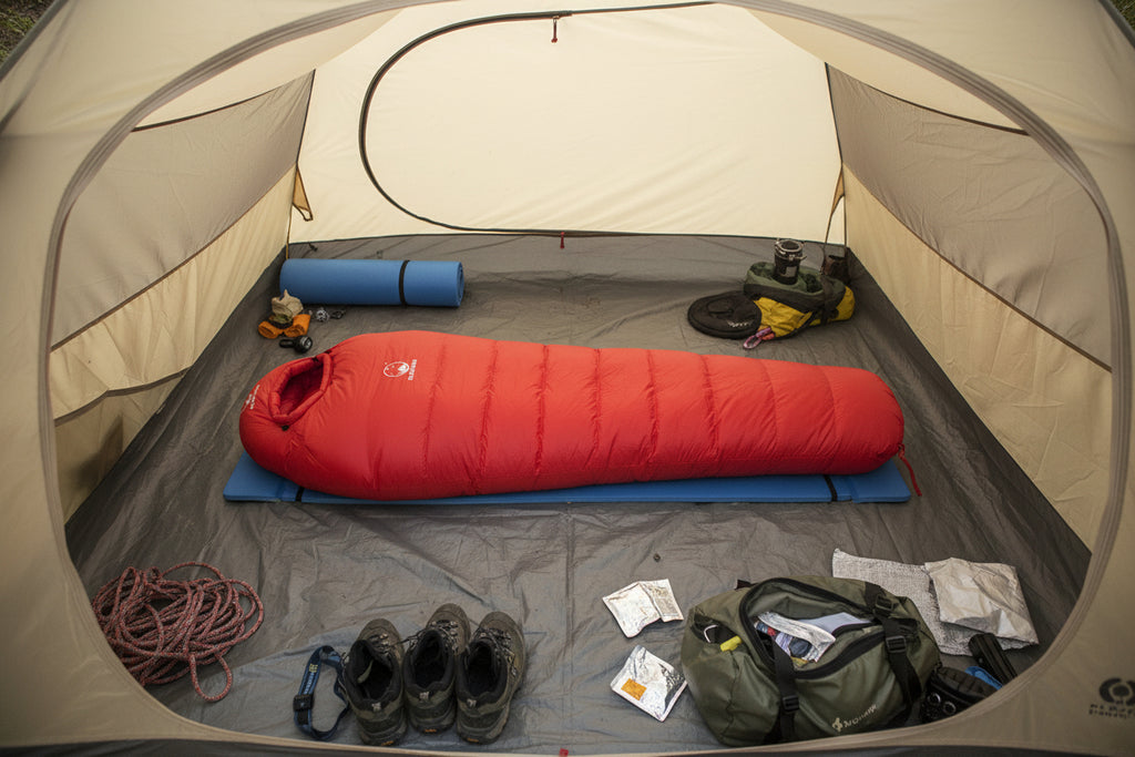 Red goose down sleeping bag offered by the best camping gear store in Vermont, the Adirondack Tool Co.