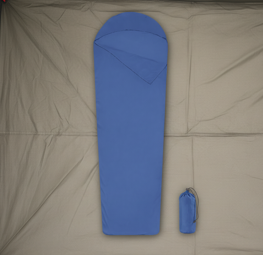 Blue sleeping bag with a matching carrying bag on a tent floor background - offered by the best camping gear store in New York, The Adirondack Tool Co.