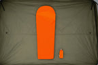 orange sleeping bag with a matching carrying bag on a tent floor background - offered by the best camping gear store in New York, The Adirondack Tool Co.