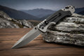 Folding knife offered by the best camping gear store on the planet, The Adirondack Tool Co. The knife sits on a textured black background