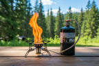 Gas canister connected to a small stove using the butane/propane tank valve conversion head offered by the Northeast's premier outdoor gear provider, The Adirondack Tool Co.