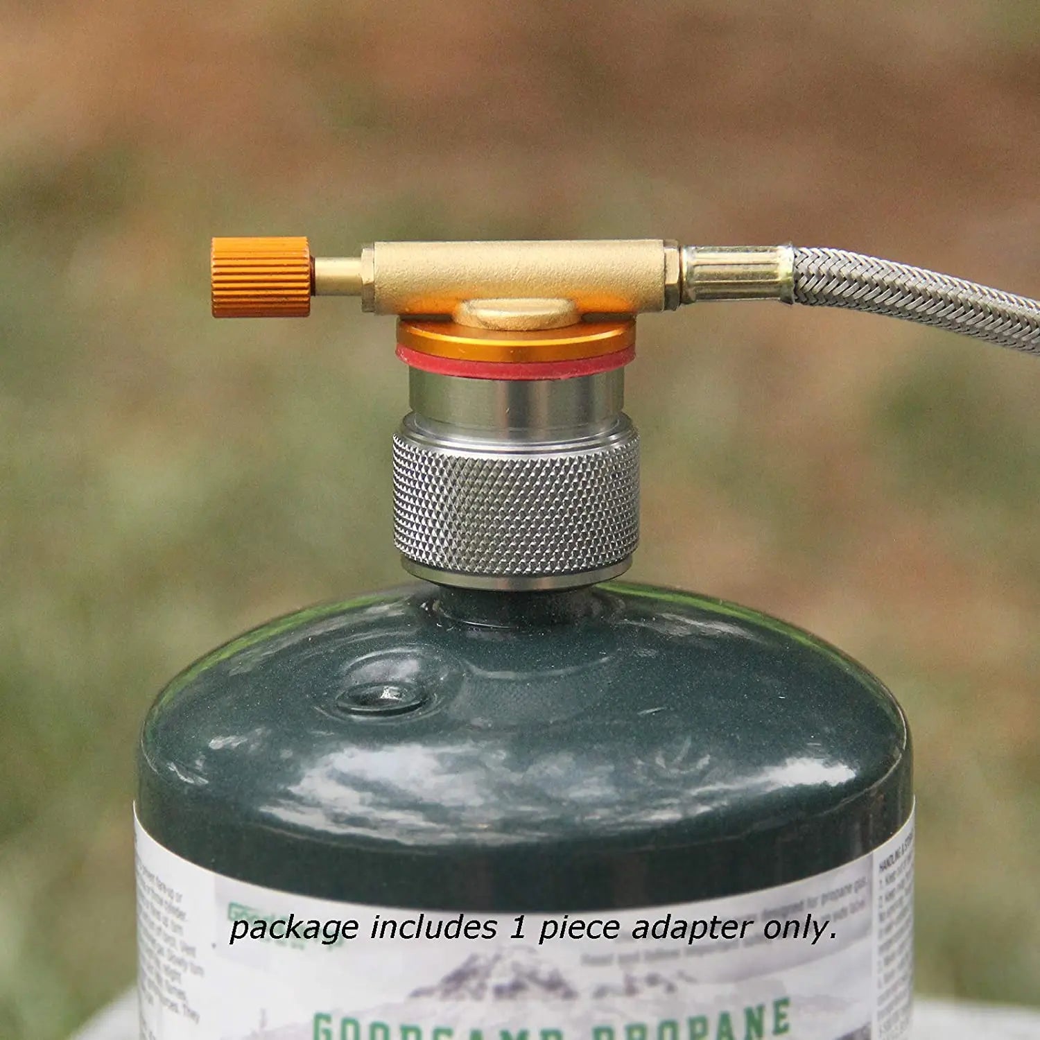 Propane tank with a metal adapter on a blurred forest background. Offered by the Northeast's premier outdoor gear provider, The Adirondack Tool Co.