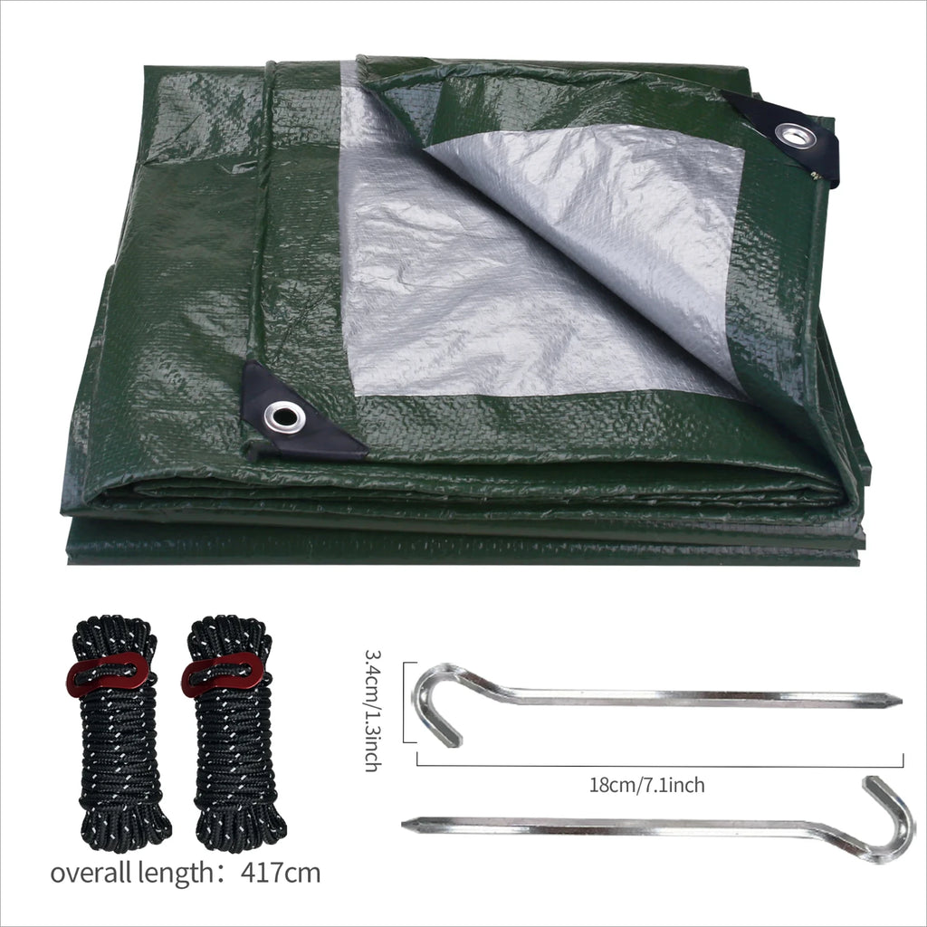 Green tarp with silver lining, ropes, and stakes on a white background, offered by the best hiking and camping gear provider in the Northeast, The Adirondack Tool Co.