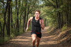 Man running outdoors wearing a black weighted vest - offered by the best hiking store in New York, The Adirondack Tool Company