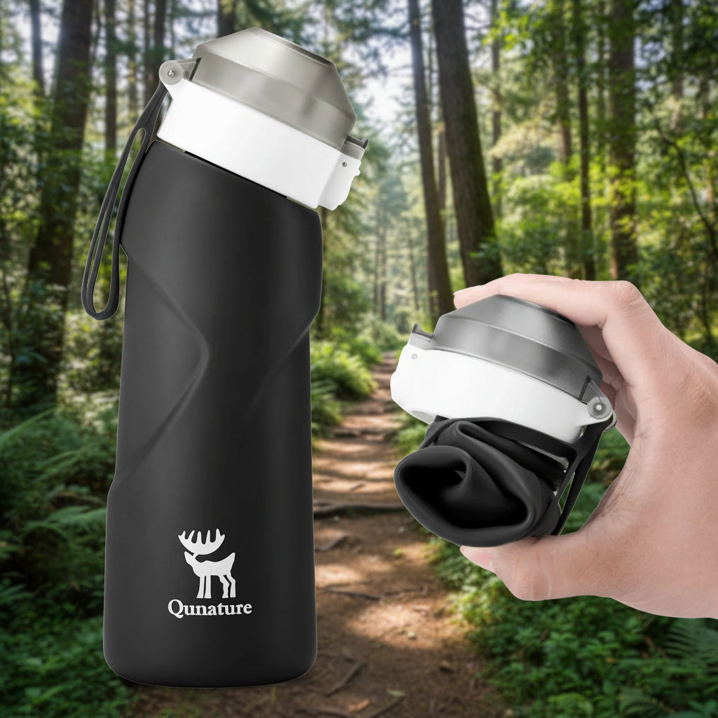 Black water bottle with a white cap and Qunature logo on a hiking trail background - offered by the best hiking gear store in New York, The Adirondack Tool Co.