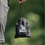 Person holding a mini air pump carry bag with Qunature logo against a blurred green background - offered by the best camping gear store in New York, The ADK Tool Co.