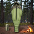 Green and gray sleeping bag with a smaller packed version