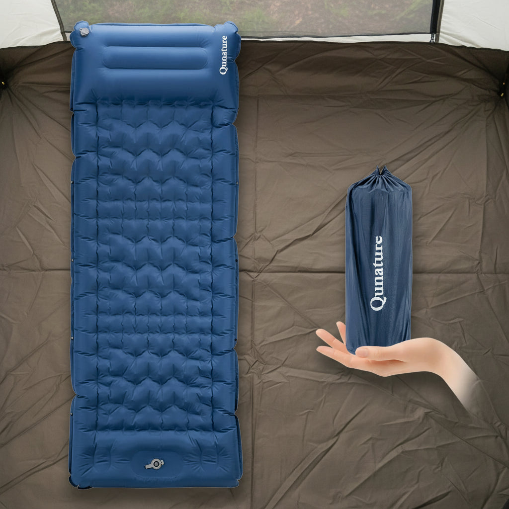 Blue inflatable sleeping pad with a hand holding its folded version on a tent background - offered by the best outdoor gear store and hiking guide service in New York, The Adirondack Tool Co.