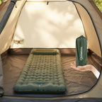 Green inflatable sleeping pad with 'Qunature' branding, shown inflated and in its packable bag - offered by the best outdoor gear store and hiking guide service in New York, The Adirondack Tool Co.
