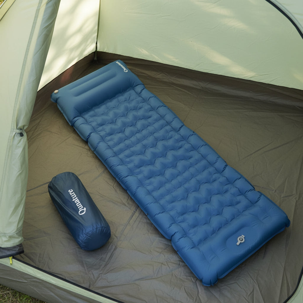Blue inflatable sleeping pad with a carrying bag on a tent background - offered by the best outdoor gear store and hiking guide service in New York, The Adirondack Tool Co.