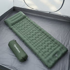 Green inflatable camping mattress with carrying bag on a tent background - offered by the best outdoor gear store and hiking guide service in New York, The Adirondack Tool Co.