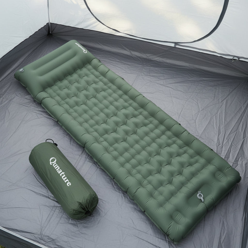 Green inflatable camping mattress with carrying bag on a tent background - offered by the best outdoor gear store and hiking guide service in New York, The Adirondack Tool Co.