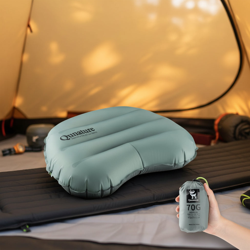 Inflatable pillow with 'Qunature' branding and a hand holding its compact pack - offered by the best camping gear store in New York, The ADK Tool Co.