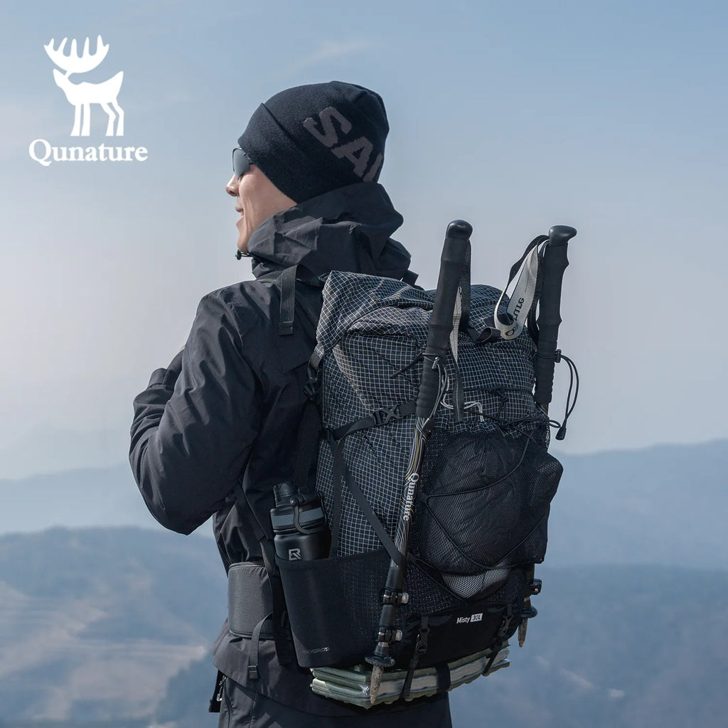 Person wearing a black backpack with a scenic background, featuring the Qunature brand logo.