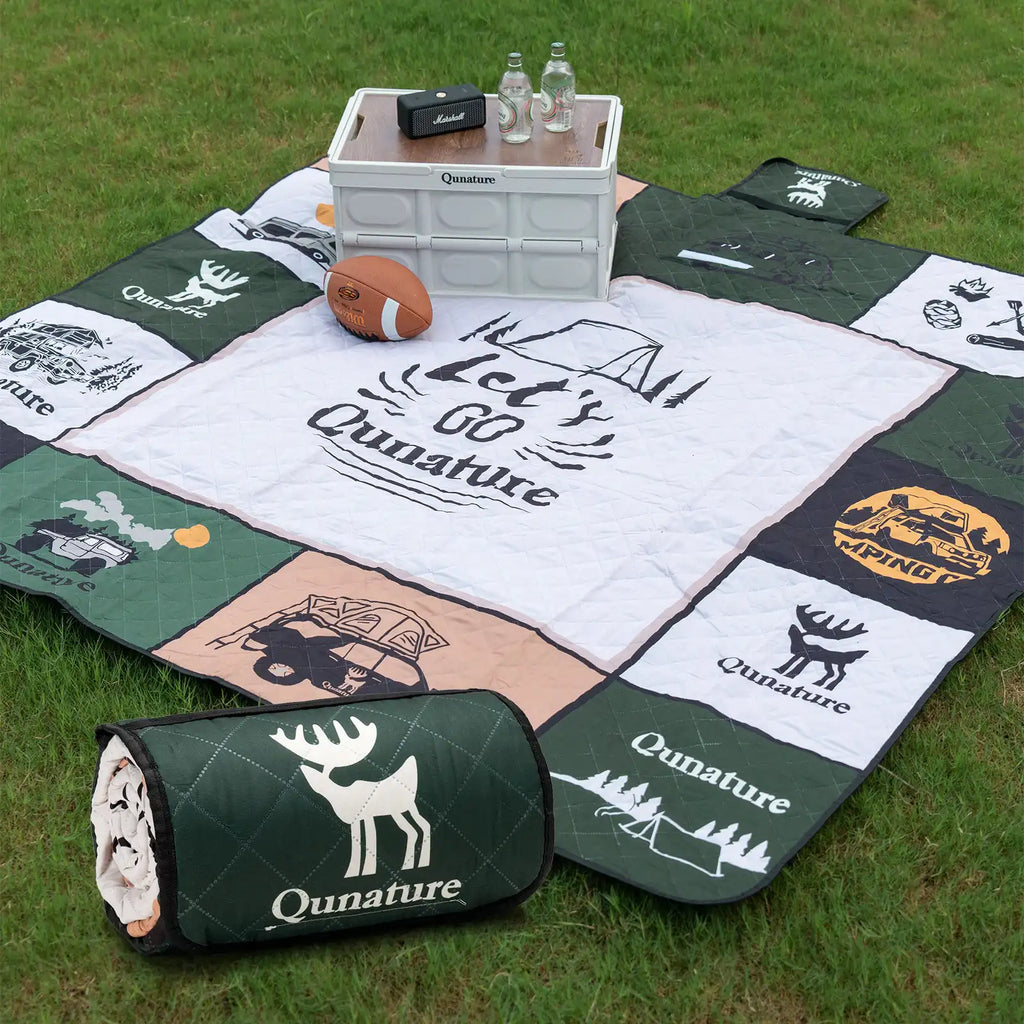 Qunature camping blanket on a grassy ground. Showed rolled and unrolled - offered by the best camping gear store in NY, The ADK Tool Co.