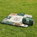 Qunature roll-up camping blanket on a grassy background - offered by the best camping gear store in New York, The Adirondack Tool Co.