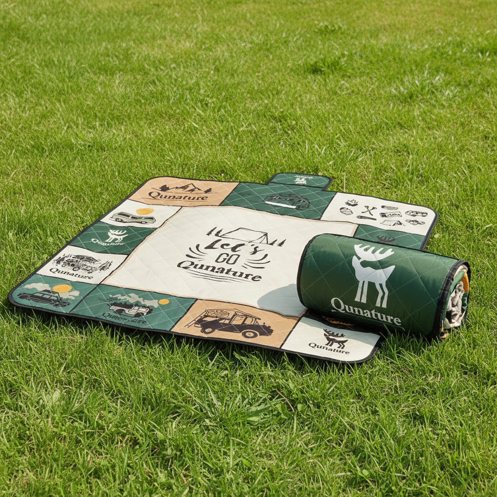 Qunature roll-up camping blanket on a grassy background - offered by the best camping gear store in New York, The Adirondack Tool Co.
