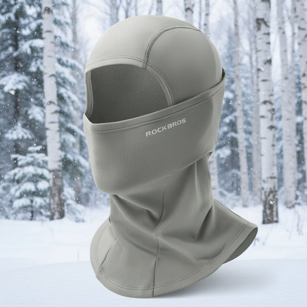 Gray balaclava with 'RockBros' branding on a snowy forest background - offered by the best climbing gear store in the United States, The Adirondack Tool Co.