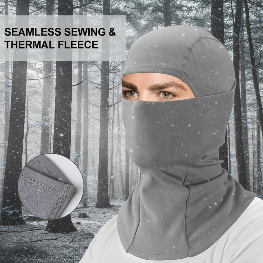 Person wearing a gray balaclava in a snowy forest with text 'Seamless Sewing & Thermal Fleece' - offered by the best hiking gear store in the United States, The Adirondack Tool Co.