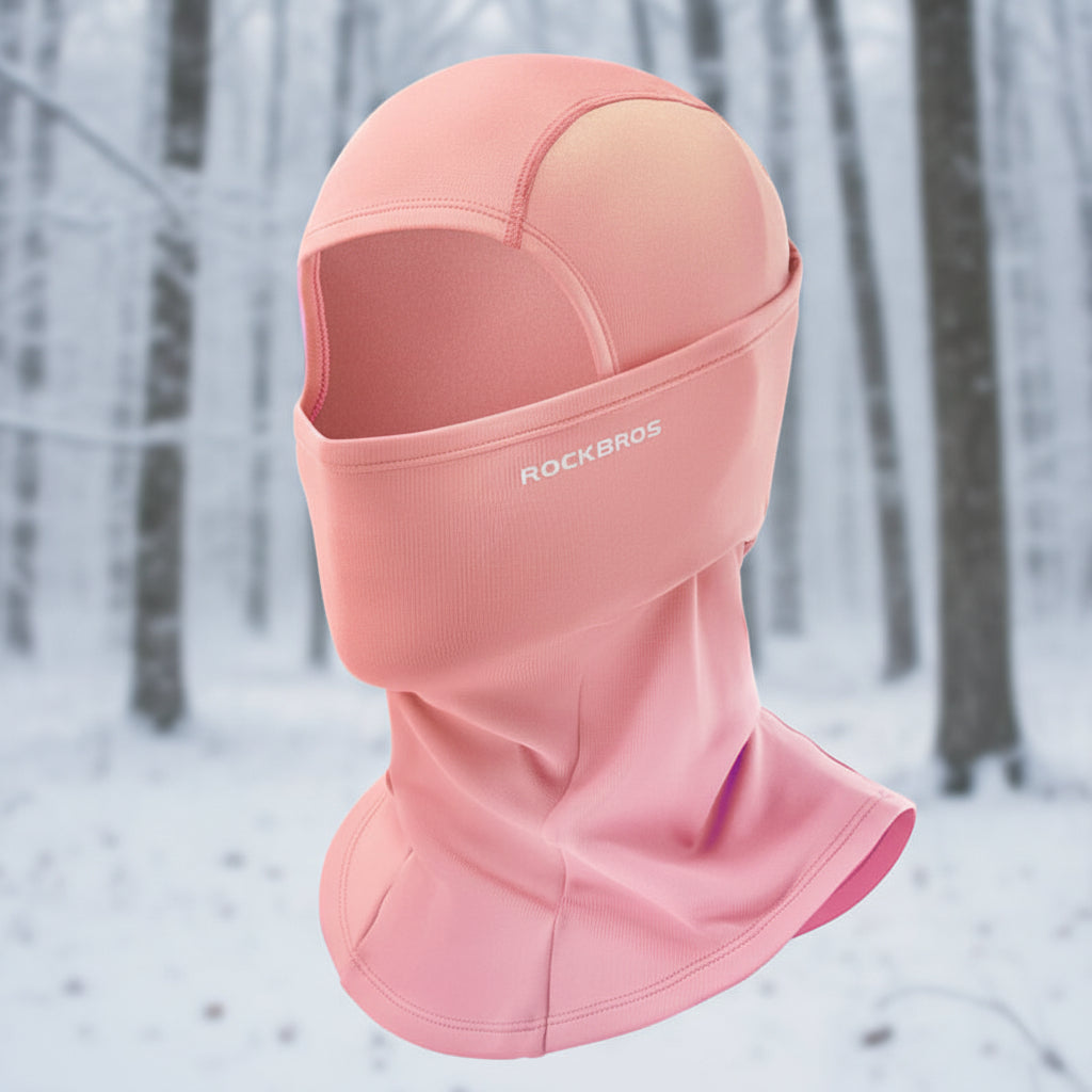 Pink balaclava with 'RockBros' branding on a snowy background - offered by the best outdoor gear store in New York, The Adirondack Tool Co.