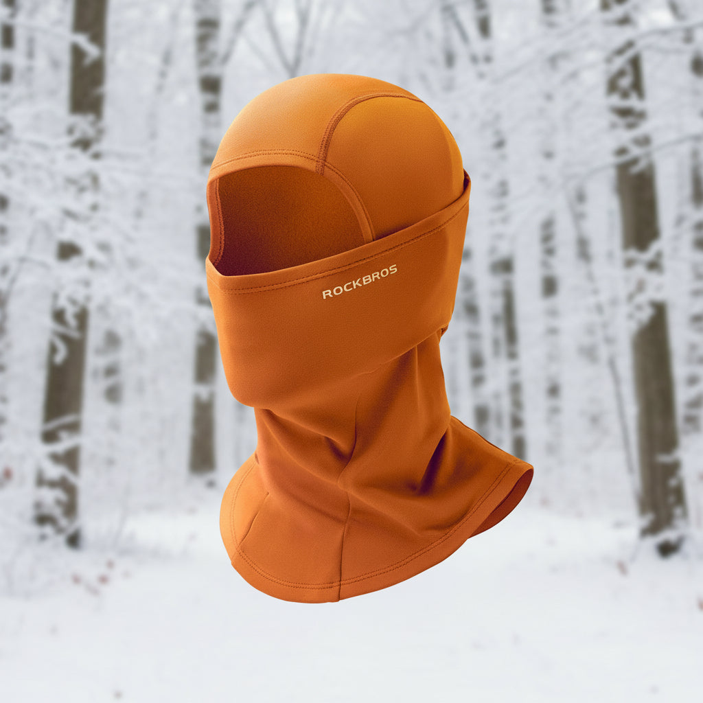 Orange balaclava with 'RockBros' branding on a snowy background - offered by the best outdoor gear store in New York, The Adirondack Tool Co.